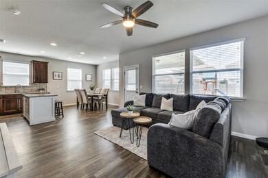 Living room featuring a ceiling fan, baseboards, 