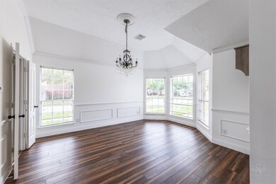The formal dining room in this exquisite home is a captivating blend of elegance and charm, featuring graceful bay windows that infuse the space with natural light and offer a delightful view of the outdoors. The bay windows not only create a sense of openness and airiness but also add a touch of architectural character to the room.