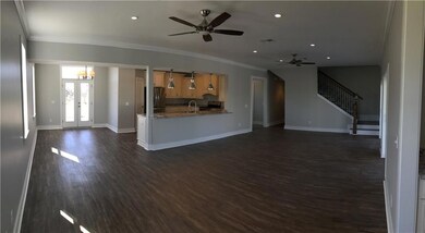 Den and dining area with open kitchen