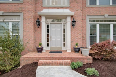 Entrance to property featuring brick siding