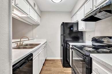 Galley kitchen with black appliances