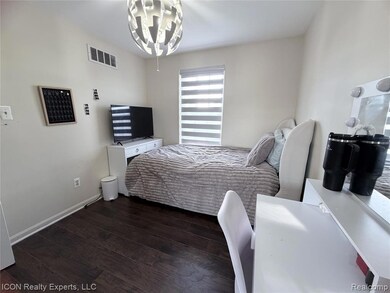 Bedroom featuring dark wood-style floors and baseboards