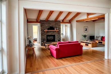 Living area featuring a fireplace, light wood finished floors, and plenty of natural light
