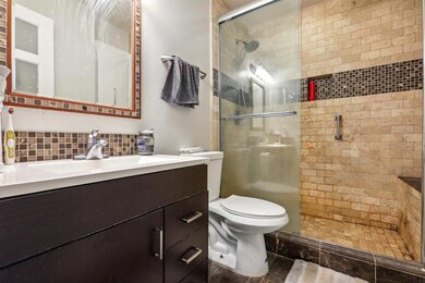 Full bathroom with decorative backsplash, a stall