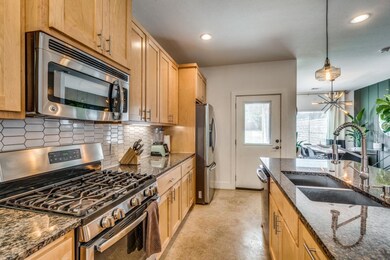 Kitchen with a sink, decorative light fixtures, t
