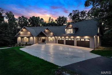 View of front of property featuring driveway, a front lawn, a porch, and a shingled roof