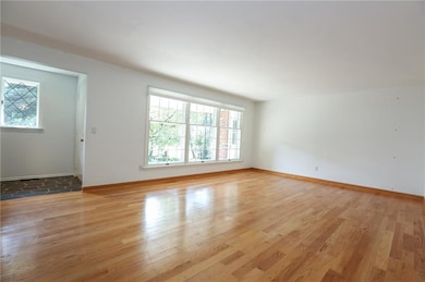 The living room is adjacent to the front foyer & i