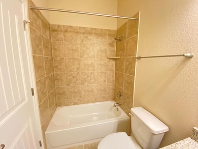 Bathroom featuring toilet, bathtub / shower combi