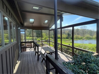 Covered porch overlooks the two ponds and even has