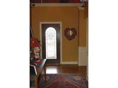 2-story foyer with leaded glass door and oak floor