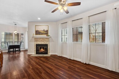 Living area featuring dark wood-style flooring, p