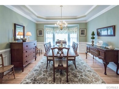 Dining room with tray ceiling, crown molding, chai