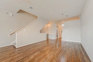 Large living/dining combo with wood flooring