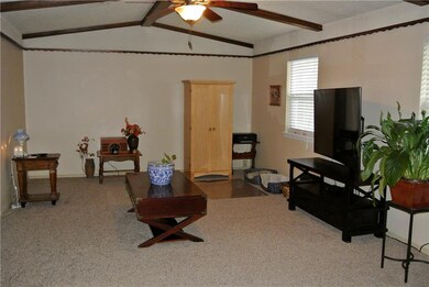 Living room with brand new carpet, windows, and bl