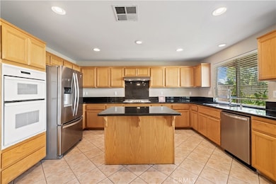 Kitchen w/center island granite countertops and stainless steel sink