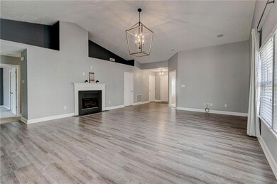 Spacious great room with fresh paint, new light fixture and luxury vinyl plank