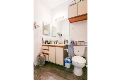 Bathroom featuring wood finished floors, toilet, 