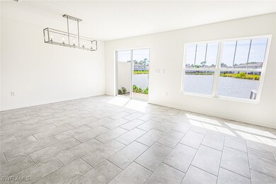 Empty room featuring a chandelier, light tile patt