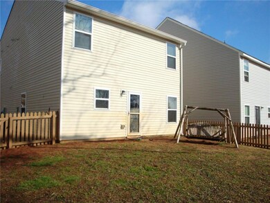 Rear view of property with a lawn