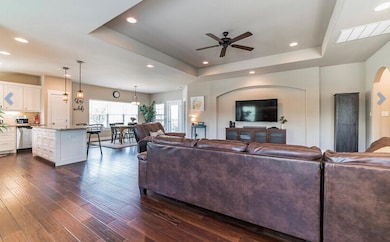 Living room with visible vents, ceiling fan, rece