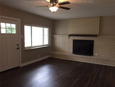 LIVING ROOM VIEW OF WOOD BURNING BUCK STOVE/FIREPL