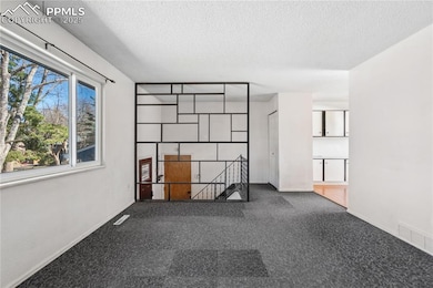 Empty room featuring baseboards, visible vents, an