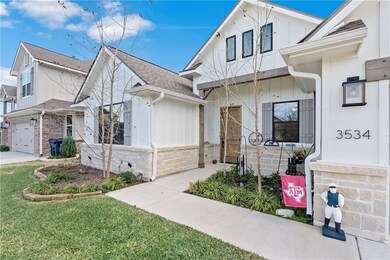 View of front of home with a front lawn and a gara