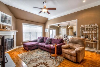 Enjoy relaxation in this great room with an open floor plan and a fireplace.