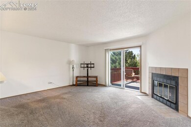 Unfurnished living room with a tiled fireplace, an