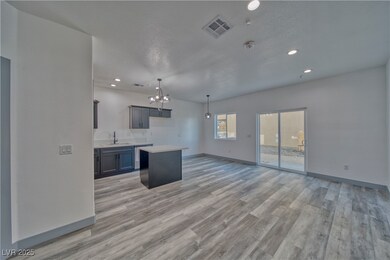 Entry to the kitchen showcasing the dining area, l