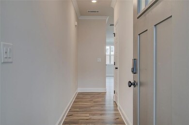 Hall with light hardwood / wood-style floors and o