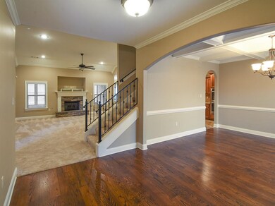 Open,light-filled spaces mark the entry of this lovely home.  Hardwood,tile,like-new carpet and smooth ceilings are some of the quality features.  The staircase leads to a huge expandable area...bedroom,mancave,bath.