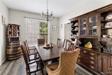 Dining area featuring a chandelier and LVP floorin
