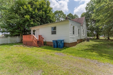 Back of house with a chimney and a deck