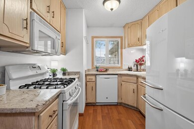 Kitchen Well-appointed kitchen with updated counters, ample cabinetry, and a window over the sink for extra light and charm.