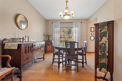 Dining space featuring baseboards, an inviting chandelier, and light wood finished floors