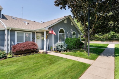 View of front of house featuring a shingled roof and a front yard