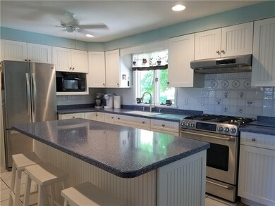 Bright and inviting kitchen with nice size island 