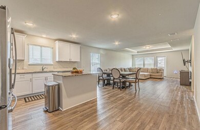 Kitchen with light wood-type flooring, white cabin