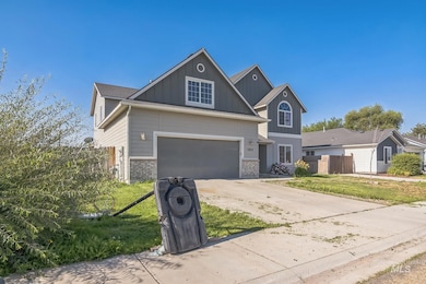 View of front facade featuring driveway, board and batten siding, and a garage