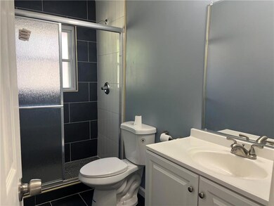 Bathroom with tile patterned floors, vanity, toile