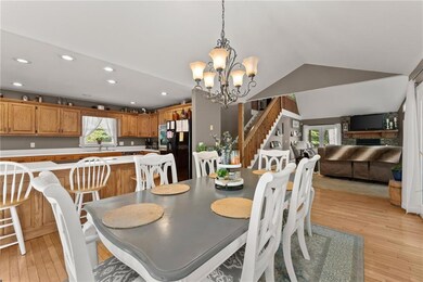 Dining room with vaulted ceiling, a fireplace, sin