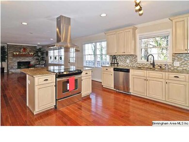 LARGE ISLAND BETWEEN KITCHEN AND FAMILY ROOM