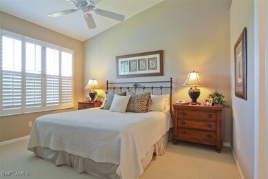 Carpeted master bedroom with ceiling fan and lofte