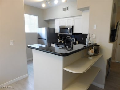 Kitchen featuring stainless steel appliances, dark