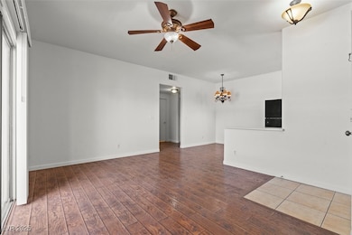 LIVING room featuring baseboards, ceiling fan with
