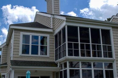 View of property exterior with a sunroom
