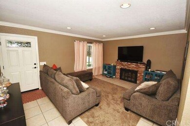 Family room shot from dining room.  A nice brick fireplace for those cozy nights.