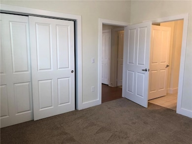 Unfurnished bedroom with carpet flooring, a close