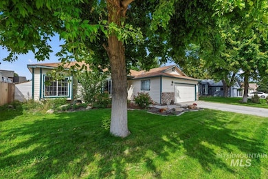 Single story home with concrete driveway and a garage